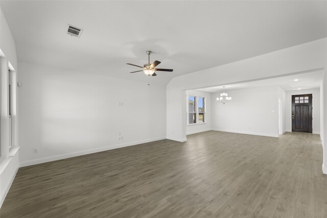 unfurnished living room with dark hardwood / wood-style floors and ceiling fan with notable chandelier