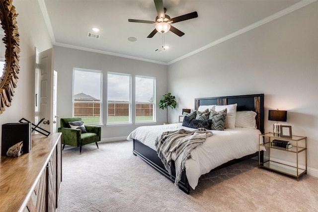 carpeted bedroom with ceiling fan and crown molding