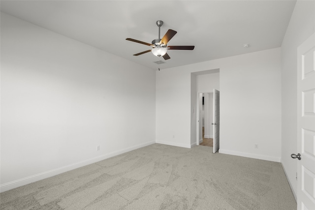 empty room featuring ceiling fan and light colored carpet