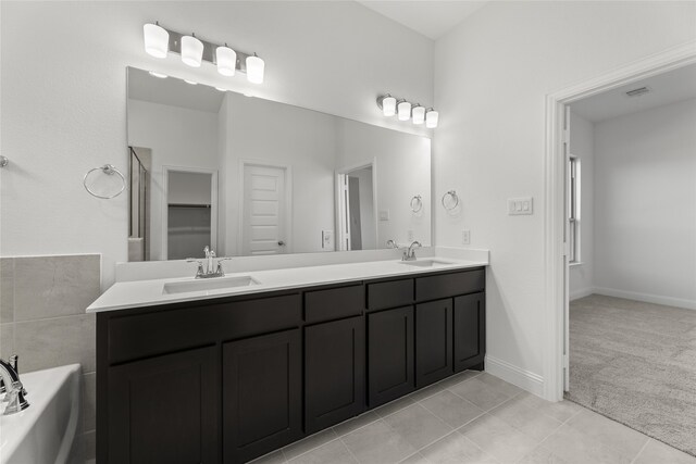 733 Lemmon Ln, Forney, TX 75126 - bathroom featuring a garden tub, a sink, visible vents, and double vanity