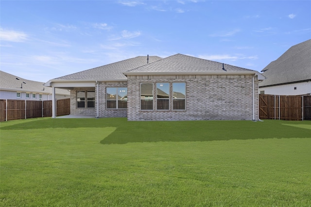 rear view of property with a lawn