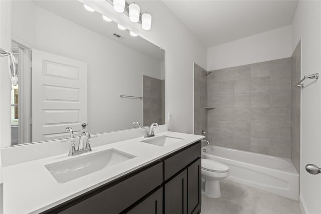 full bathroom with toilet, tile patterned flooring, vanity, and tiled shower / bath