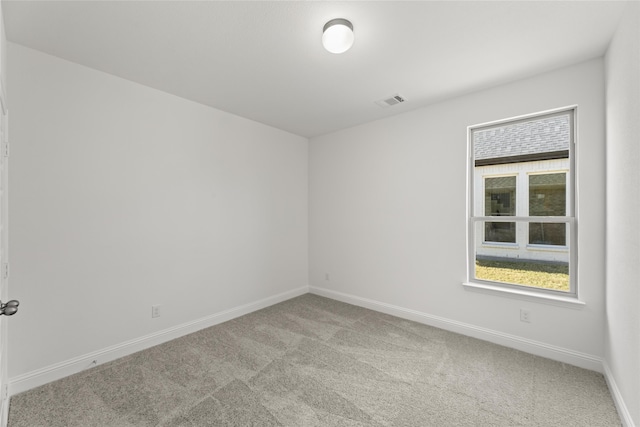 empty room featuring light colored carpet