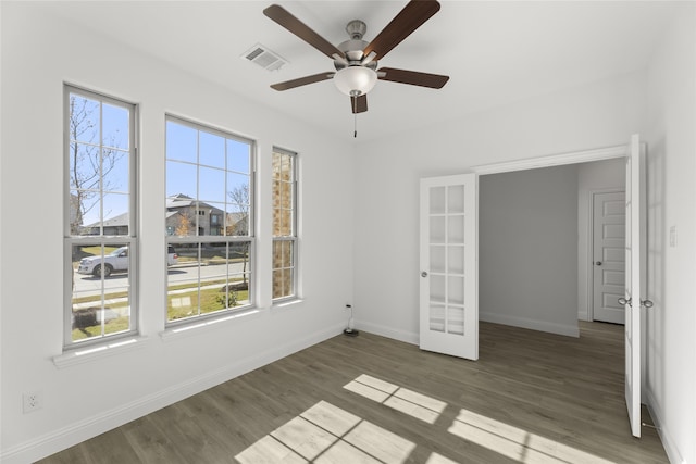 unfurnished room featuring ceiling fan, french doors, and dark wood-type flooring