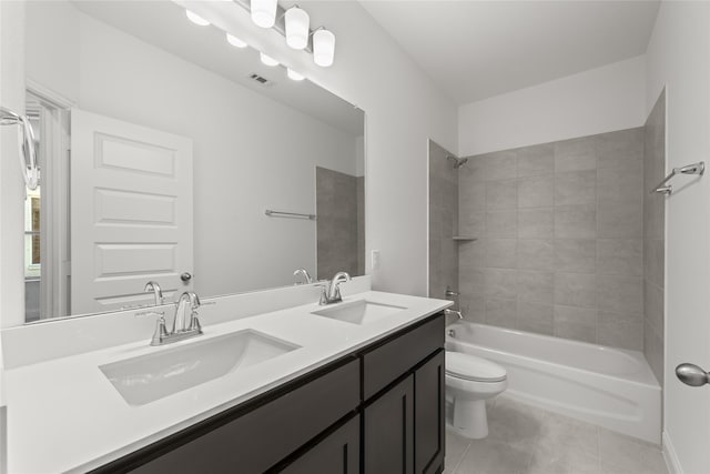 full bathroom with vanity, tiled shower / bath combo, tile patterned floors, and toilet