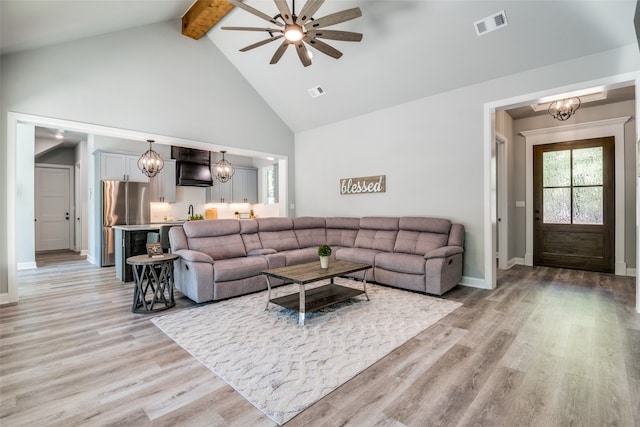 living room featuring ceiling fan, sink, high vaulted ceiling, beamed ceiling, and light hardwood / wood-style floors