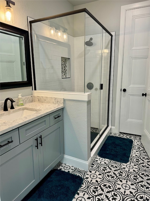 bathroom with tile patterned floors, vanity, and an enclosed shower