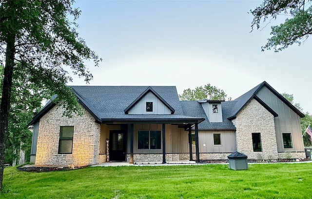 rear view of property featuring a yard