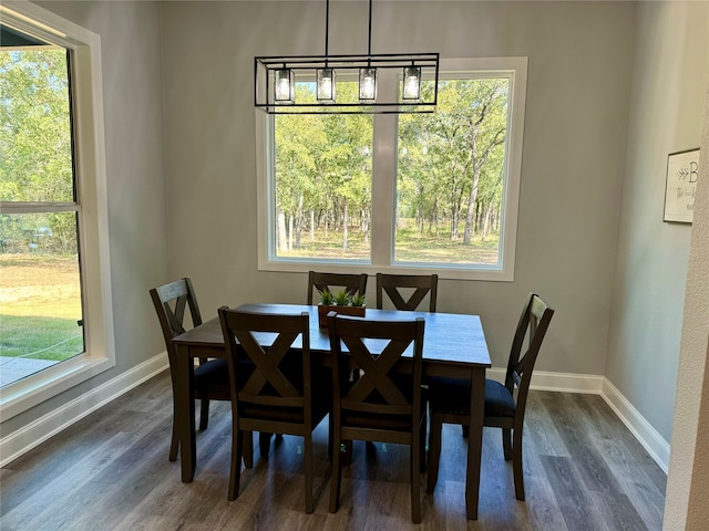 dining space with a chandelier and dark wood-type flooring