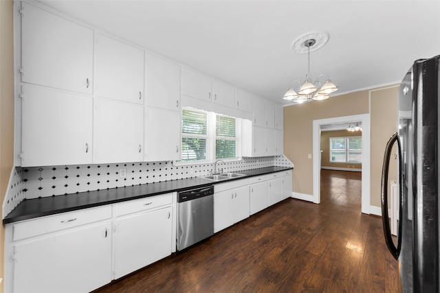 kitchen featuring dishwasher, black fridge, white cabinetry, decorative light fixtures, and decorative backsplash