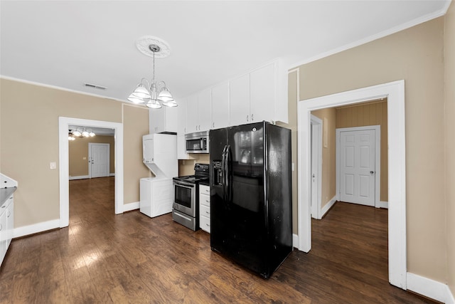 kitchen with hanging light fixtures, appliances with stainless steel finishes, white cabinetry, dark wood-type flooring, and crown molding