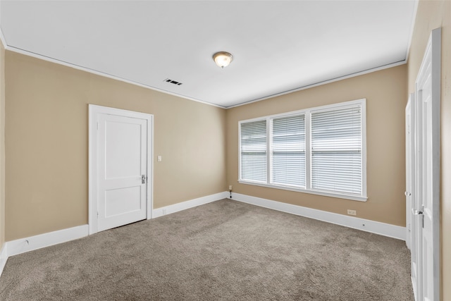 carpeted spare room featuring ornamental molding