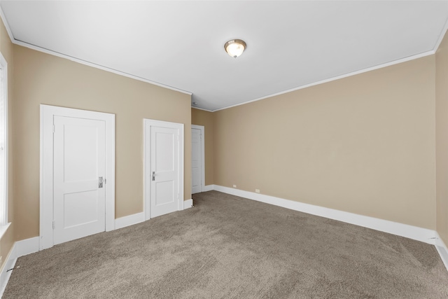 unfurnished bedroom featuring carpet and crown molding