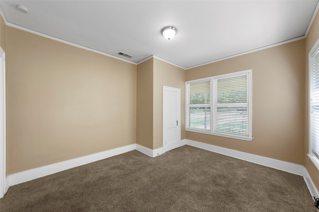 unfurnished room featuring crown molding and dark colored carpet