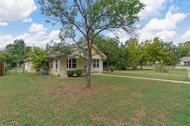 view of front of home with central AC and a front lawn