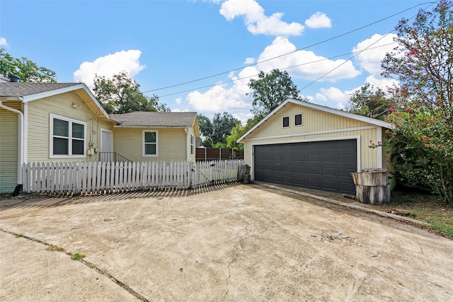 view of side of home featuring an outbuilding and a garage