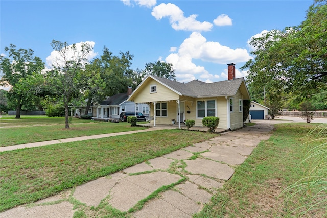 view of front of home featuring a porch, a front lawn, and a garage