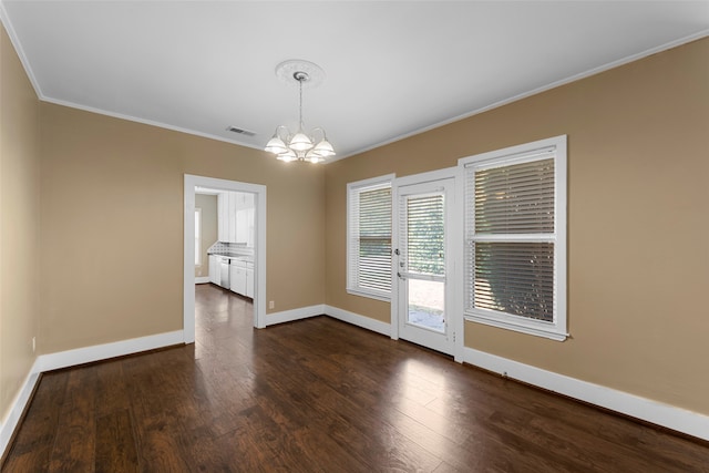 unfurnished dining area with ornamental molding, dark hardwood / wood-style flooring, and an inviting chandelier