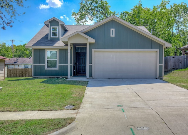 view of front of home with a garage, fence, concrete driveway, and a front yard
