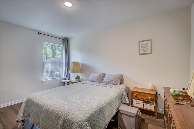 bedroom with dark wood-type flooring