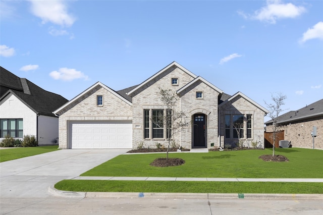 french country style house with central AC, a garage, and a front lawn