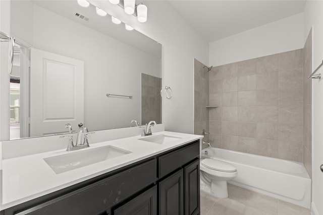 full bathroom featuring tile patterned flooring, vanity, toilet, and tiled shower / bath