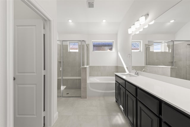 bathroom with vanity, tile patterned floors, and independent shower and bath