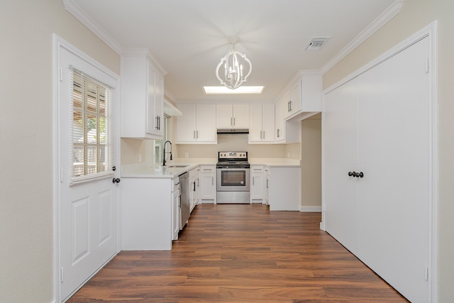 kitchen with white cabinetry, sink, hanging light fixtures, dark wood-type flooring, and stainless steel appliances