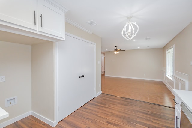 spare room with hardwood / wood-style flooring and ceiling fan with notable chandelier