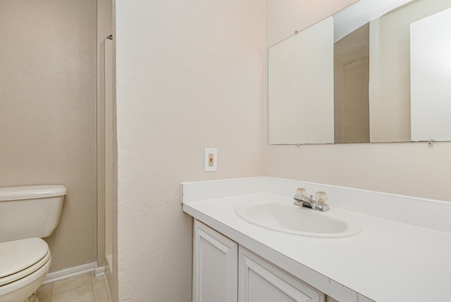 bathroom featuring tile patterned floors, vanity, and toilet