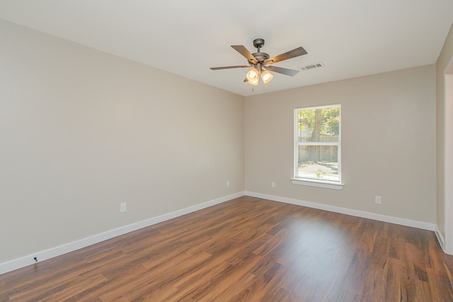 spare room with ceiling fan and dark hardwood / wood-style flooring