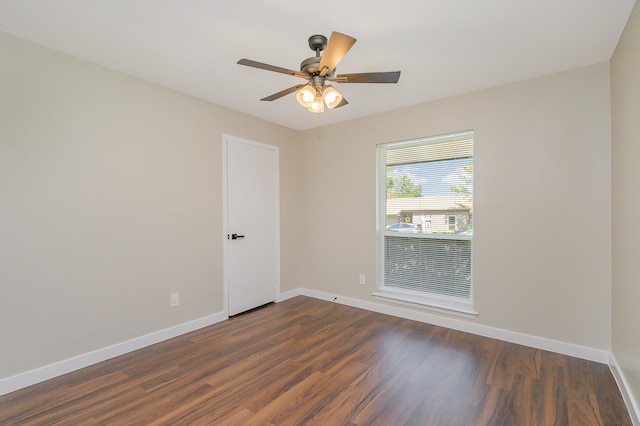 empty room featuring dark hardwood / wood-style floors and ceiling fan