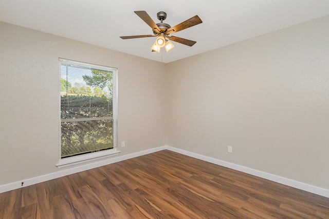 unfurnished room with ceiling fan and dark hardwood / wood-style flooring