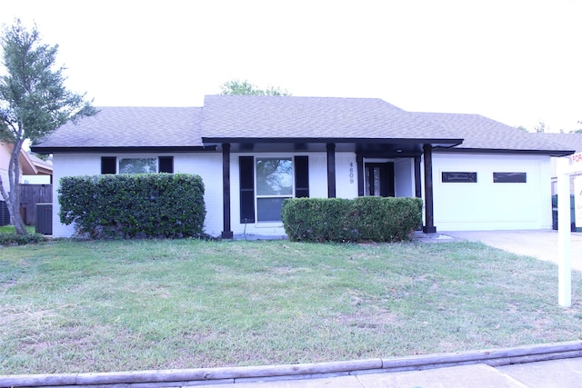 single story home featuring a front yard, central AC, and a garage