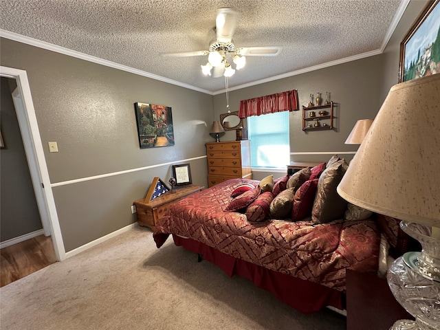 carpeted bedroom with a textured ceiling, ornamental molding, and ceiling fan