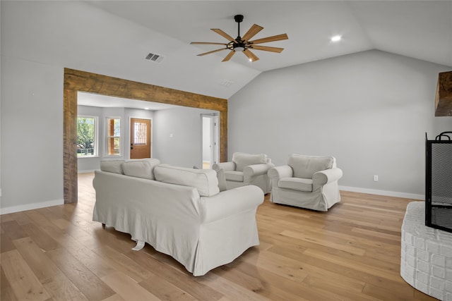 living room with ceiling fan, vaulted ceiling, and light hardwood / wood-style floors