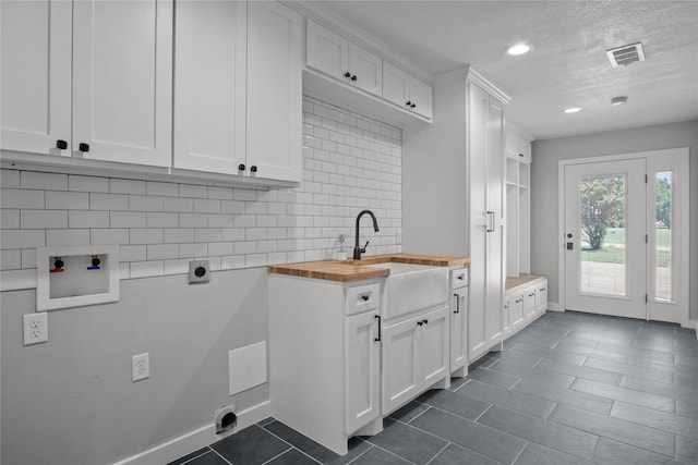 laundry area with cabinets, electric dryer hookup, washer hookup, and sink