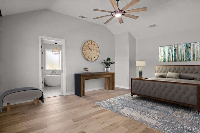 bedroom with lofted ceiling, light hardwood / wood-style floors, ensuite bath, and ceiling fan