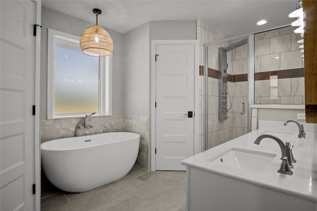 bathroom with vanity, separate shower and tub, and tile walls