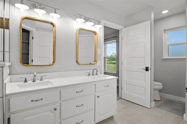 bathroom with vanity, toilet, and tile patterned floors