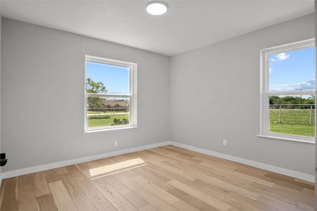 spare room featuring light hardwood / wood-style floors