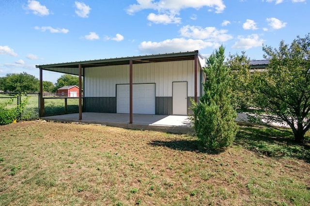 view of outbuilding featuring a yard and a garage