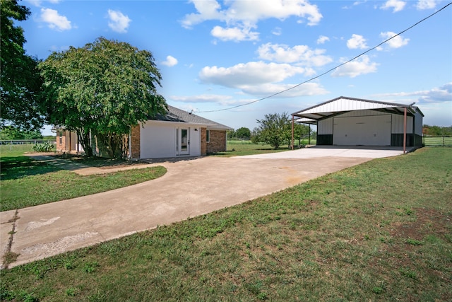 view of front of property with a front yard, a garage, and a carport