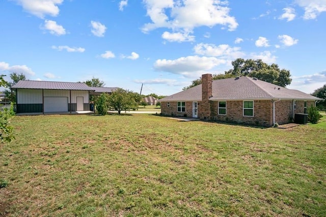 view of yard with a garage and central air condition unit