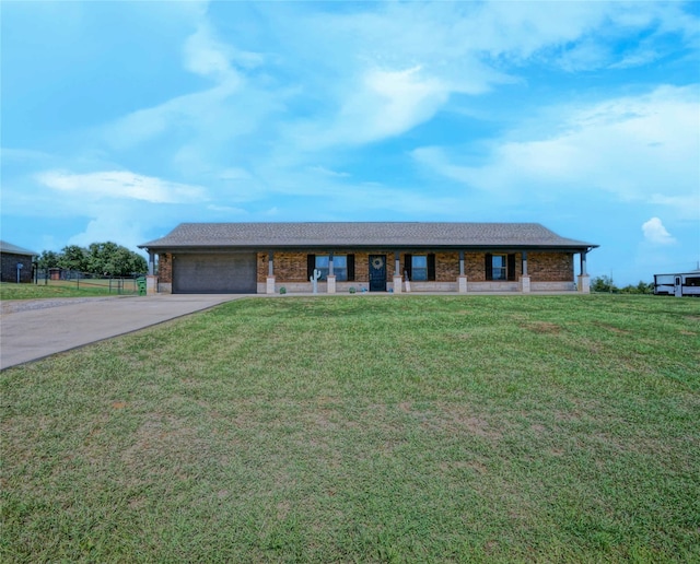 ranch-style home featuring a garage and a front yard