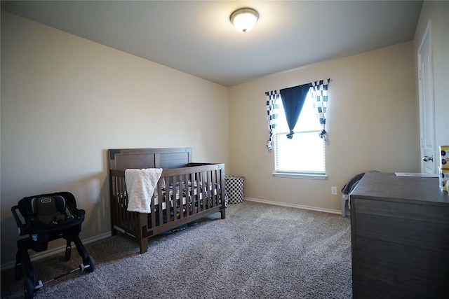 carpeted bedroom featuring a nursery area