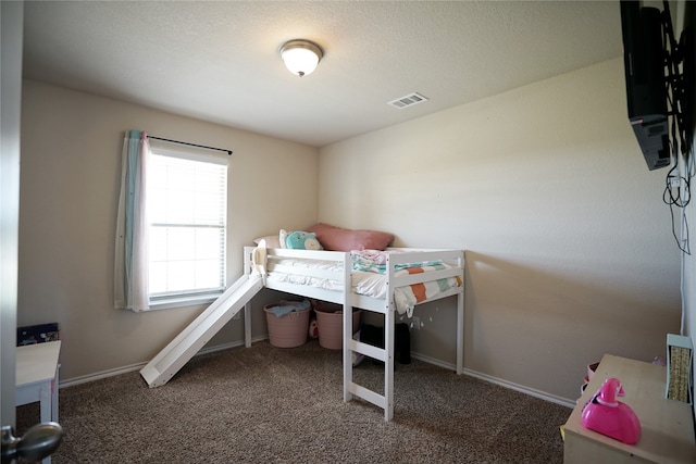 bedroom with dark colored carpet