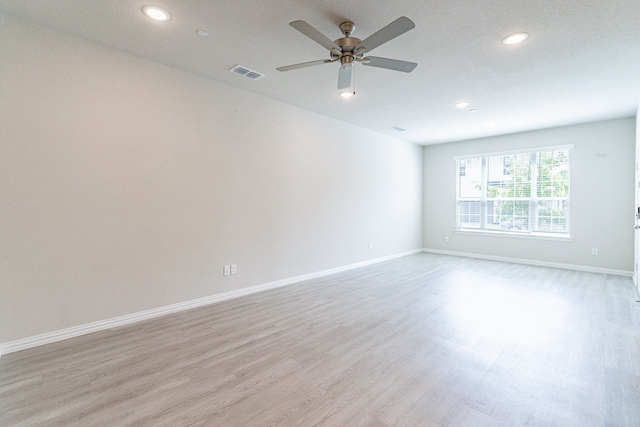 unfurnished room featuring light hardwood / wood-style flooring and ceiling fan