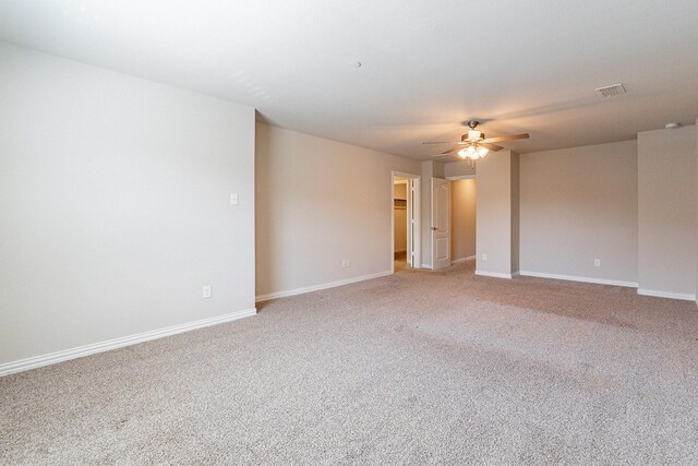 unfurnished room with carpet and ceiling fan