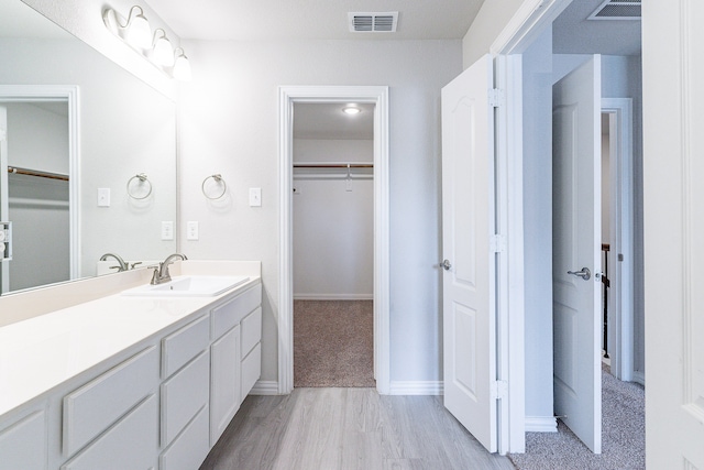 bathroom with wood-type flooring and vanity